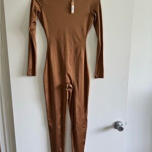 Skims ALL-IN-ONE SHINE CREW NECK LONG SLEEVE ONESIE